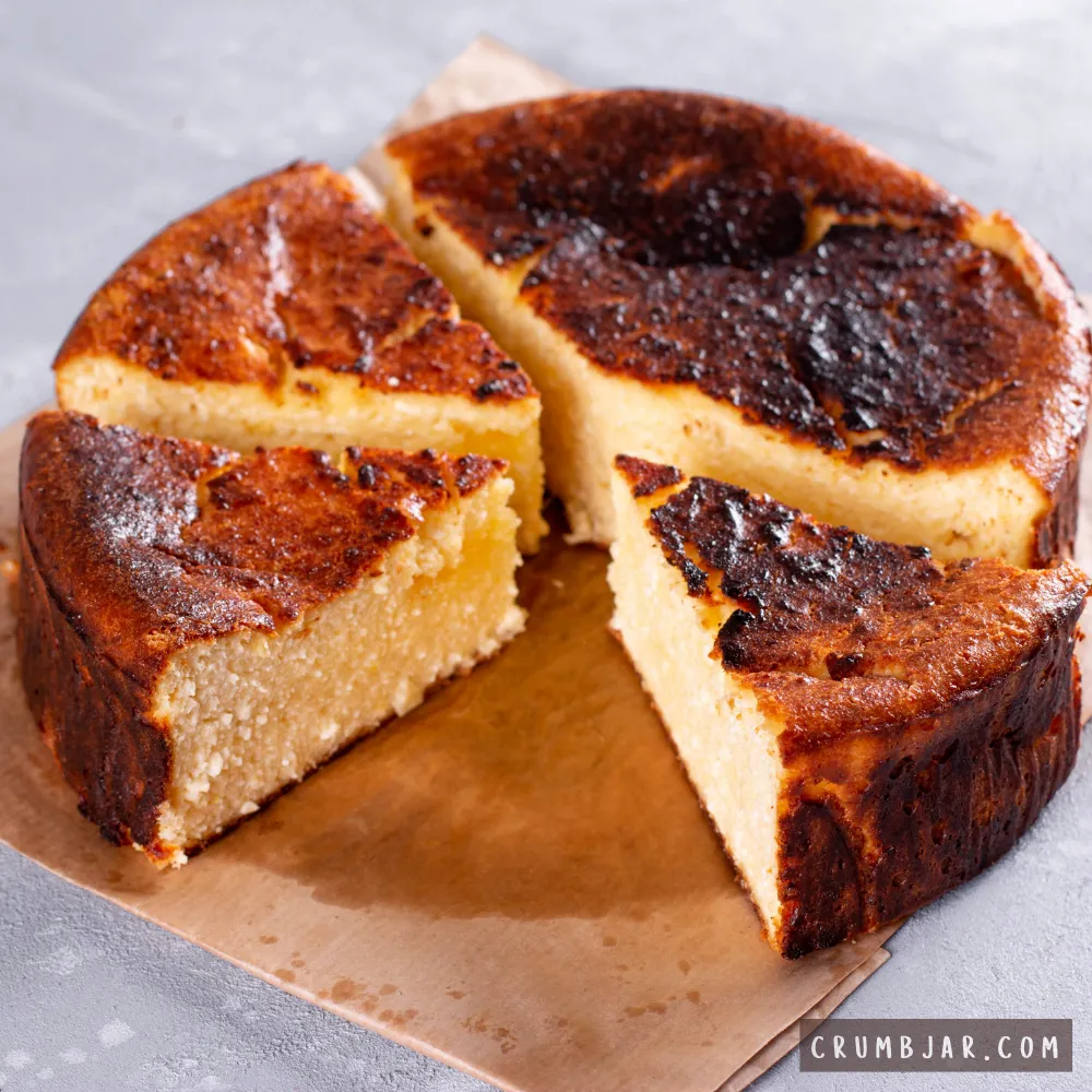 Sliced round cake with a dark, unevenly burnt top crust and dense pale interior resting on parchment paper, illustrating "My recipe turned out completely different from expected."